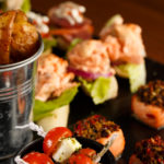 Selection of finger buffet food showing chips, and tomatoes with feta, as part of mercure hotels meeting food offering