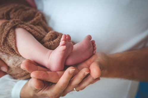 Baby feet in parent's hands