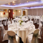 The buchanan suite set for a wedding breakfast with purple lighting at mercure glasgow city hotel