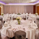 The buchanan suite set for a wedding breakfast with purple lighting at mercure glasgow city hotel