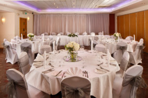 The buchanan suite set for a wedding breakfast with purple lighting at mercure glasgow city hotel