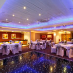 The buchanan suite set for a wedding breakfast with the dance floor lit up at mercure glasgow city hotel