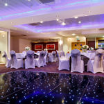 The buchanan suite set for a wedding breakfast with the dance floor lit up at mercure glasgow city hotel