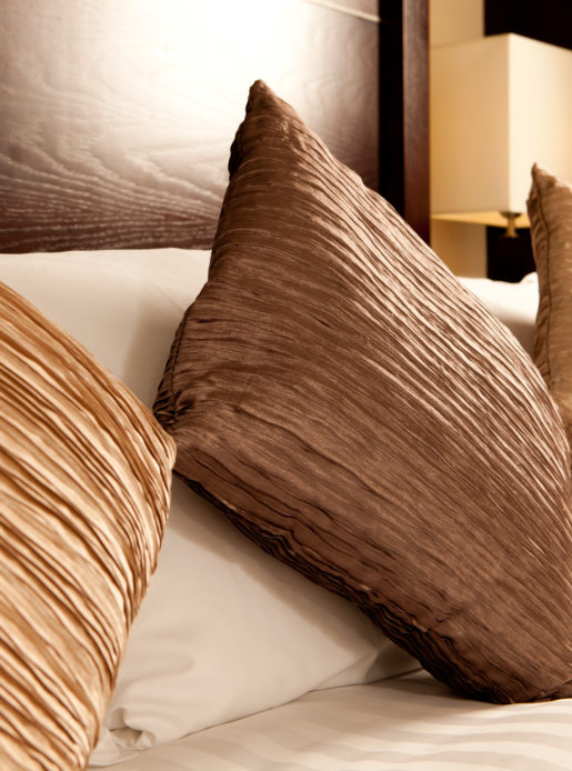Detail of cushions on a double bed in a bedroom at mercure glasgow city hotel