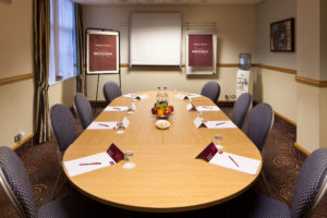 A board table and chairs in the trader room prepared set for a meeting at mercure glasgow city hotel
