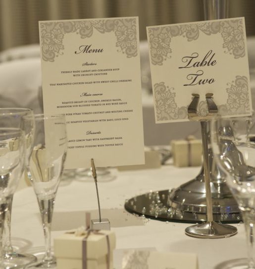 Close up of a name card and place setting at a wedding in The Lakeside Suite at Mercure Gloucester Bowden Hall Hotel