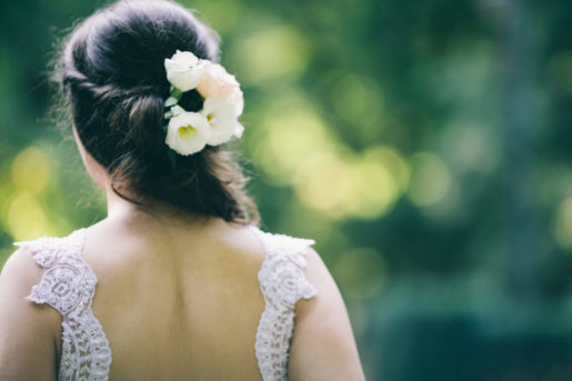 Back of a woman with beautiful hairstyle and white dress