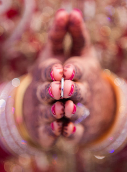 Indian bride holding ring, traditional Indian wedding.