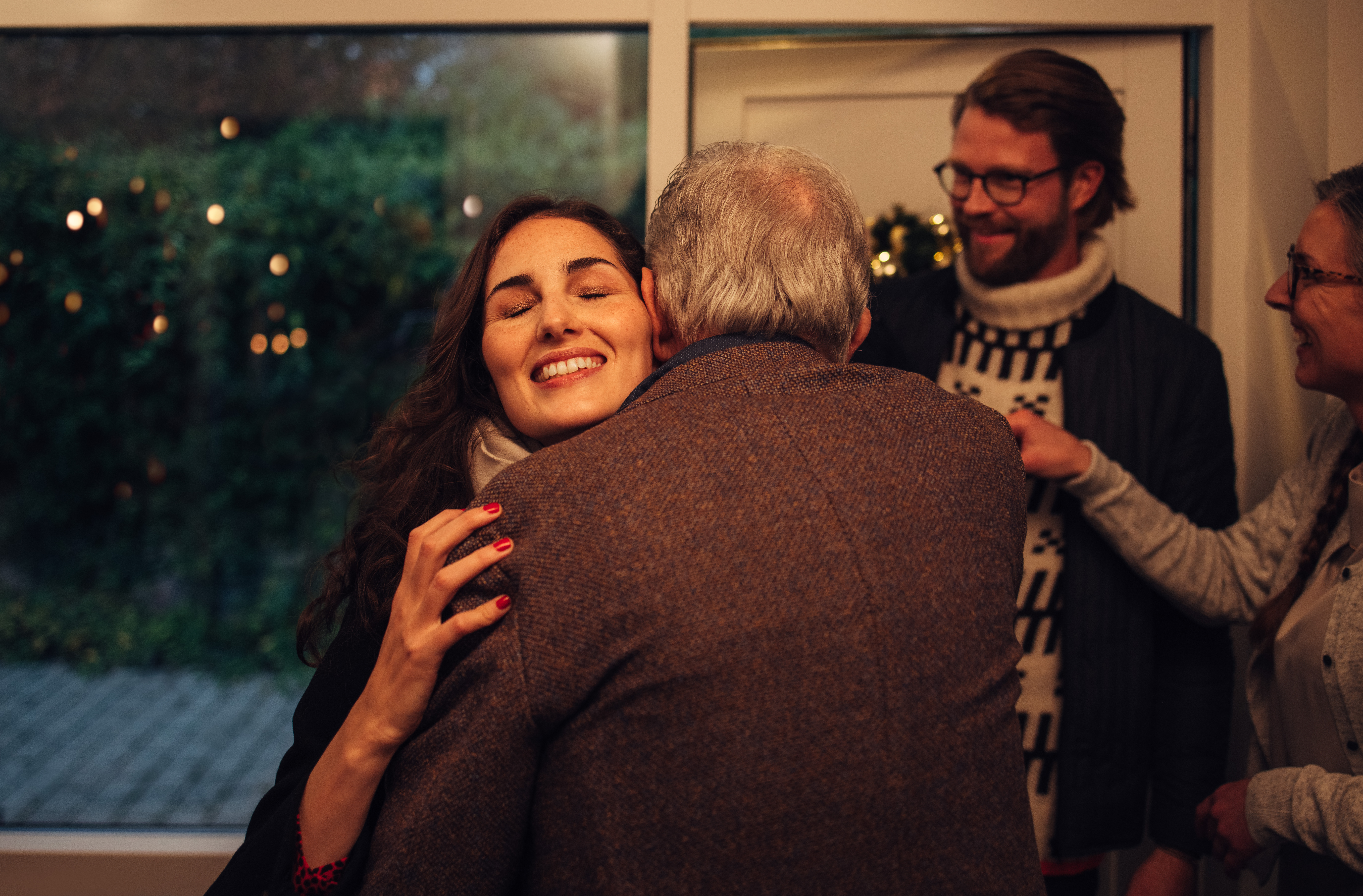 Family,Coming,Over,For,Christmas,Dinner,At,The,Grandparents,Home. Couple visiting family